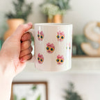 Person holding a mug with a baby's face multiplied around the mug in rows. Final product comes with images provided by customer. Shown in 11oz size.