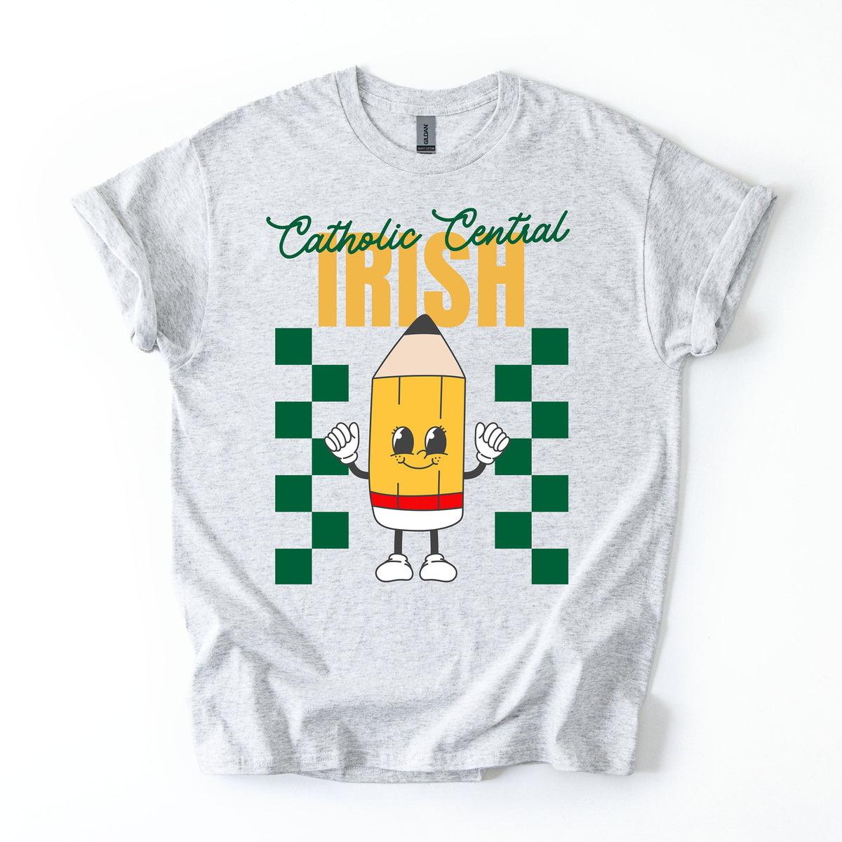 White t-shirt with a colorful design featuring a pencil character and text "Catholic Central Irish" on a white background